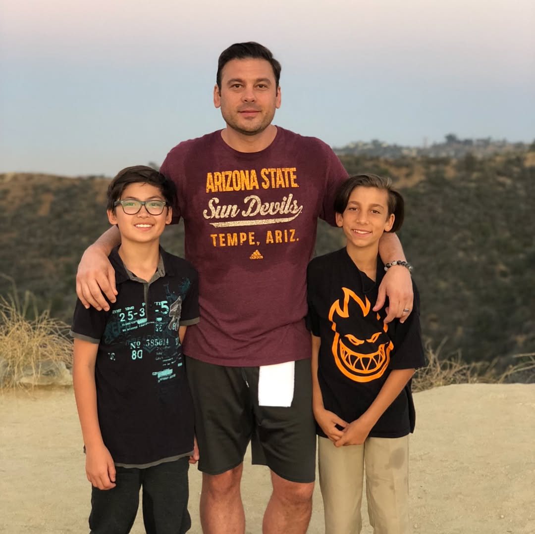 Roland with his two older sons on a hill